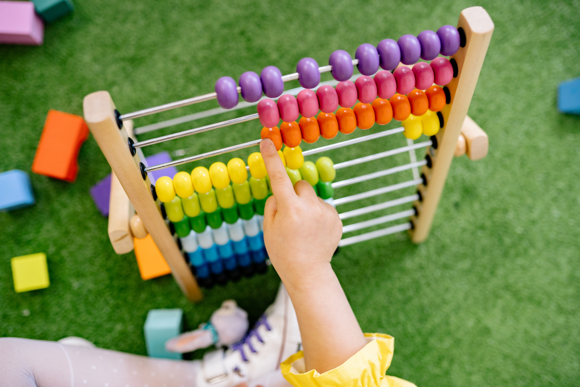 Child using toy bead counter