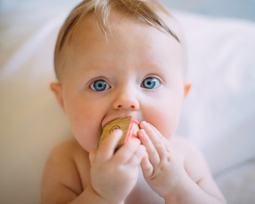 Baby with toy block