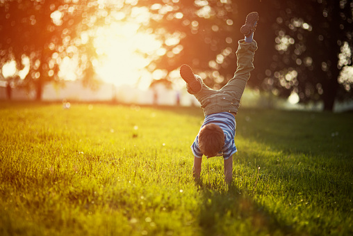 Child doing cartwheel outside