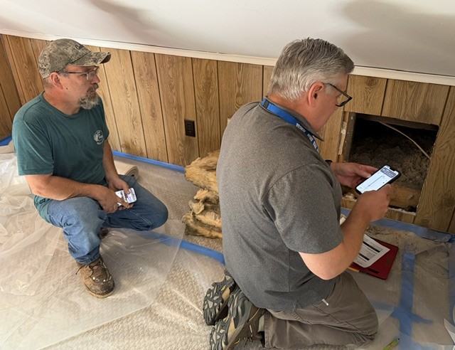 Weatherization inspection taking place with two men working in house