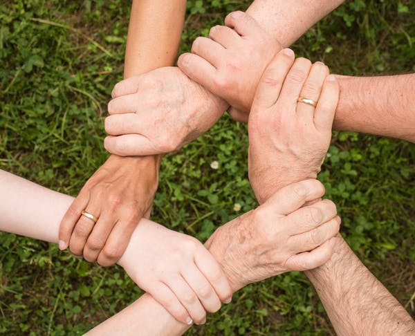 Image of group holding hands for support